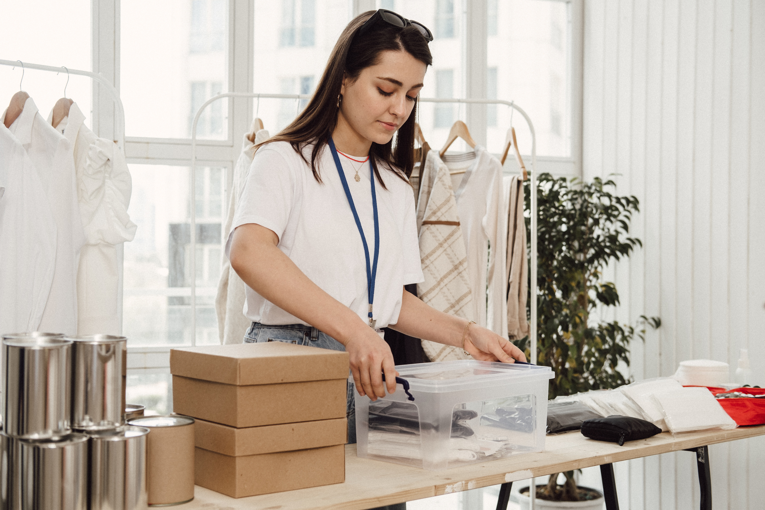 Woman Arranging Boxes of Donations