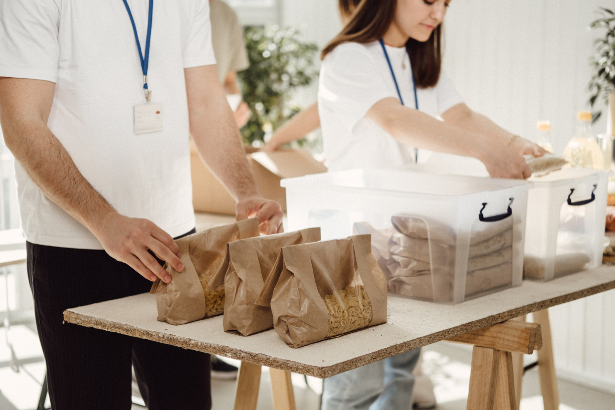 Volunteers Arranging Bags of Food Donations